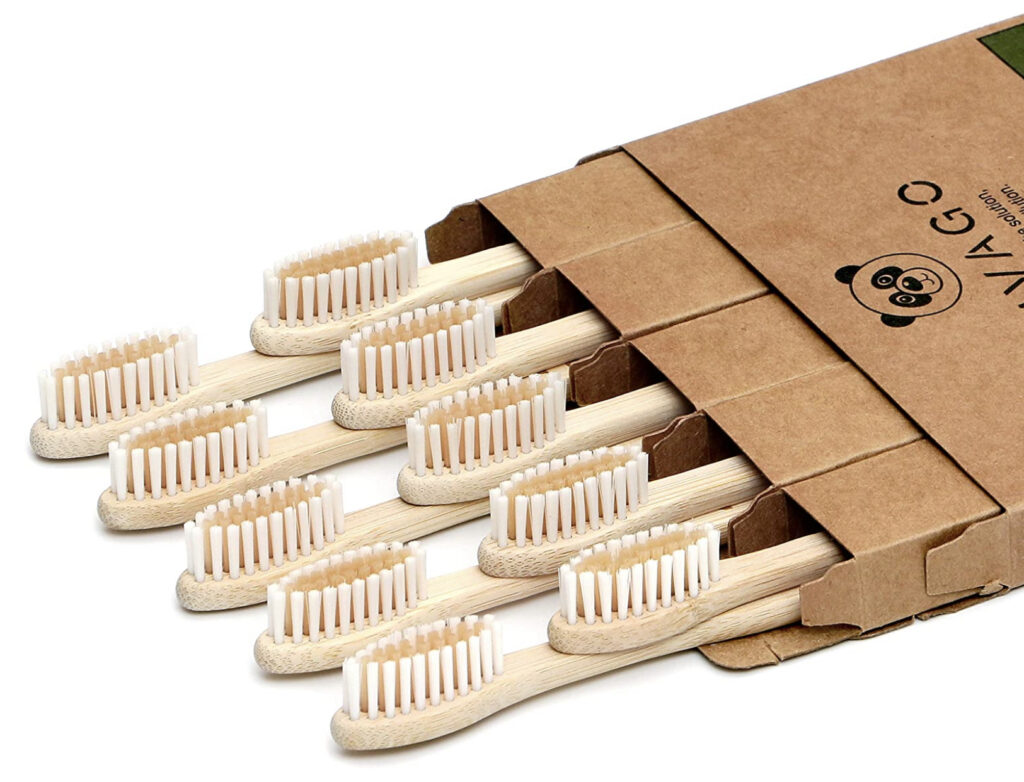 Bamboo toothbrushes laying down poking out of the box.