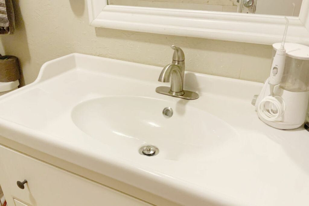 An after shot of a bathroom sink that has been cleaned properly. 