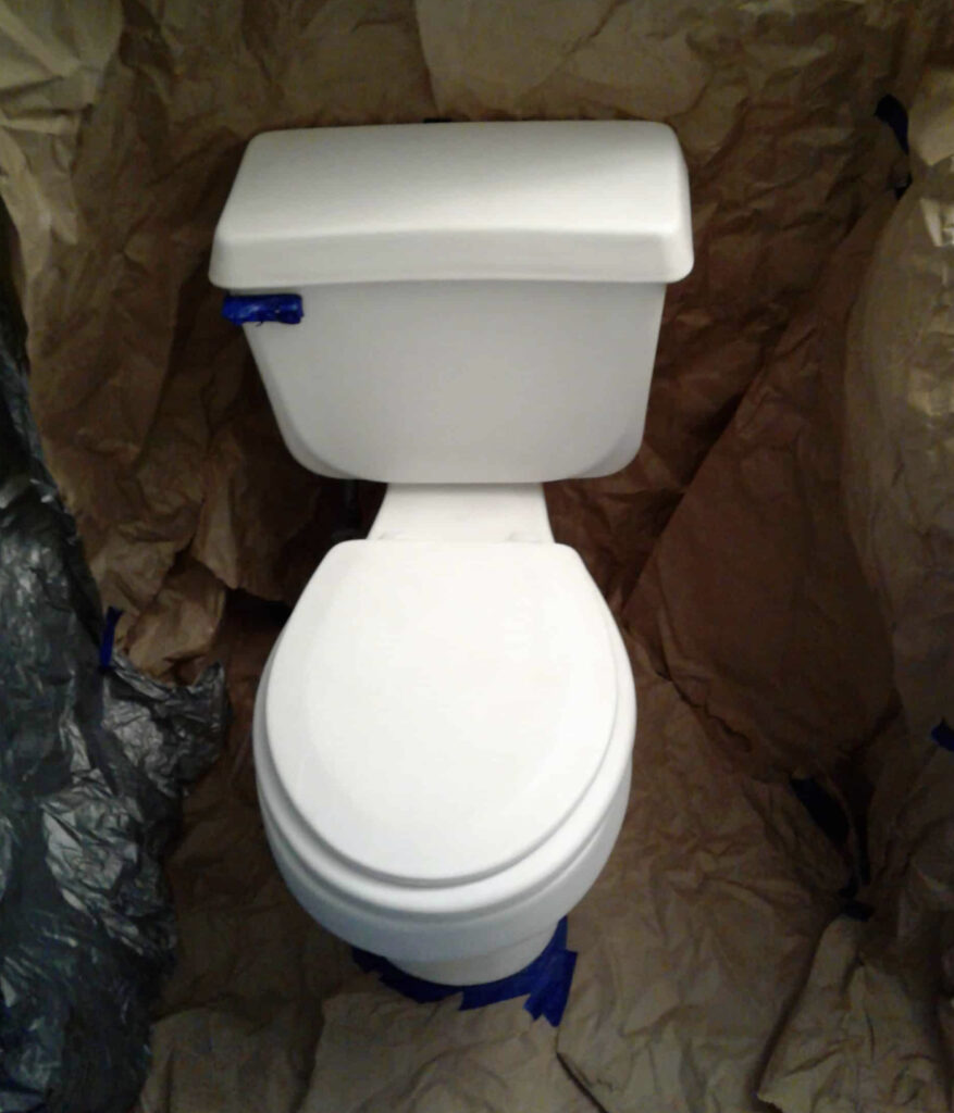 White toilet being prepped for primer.