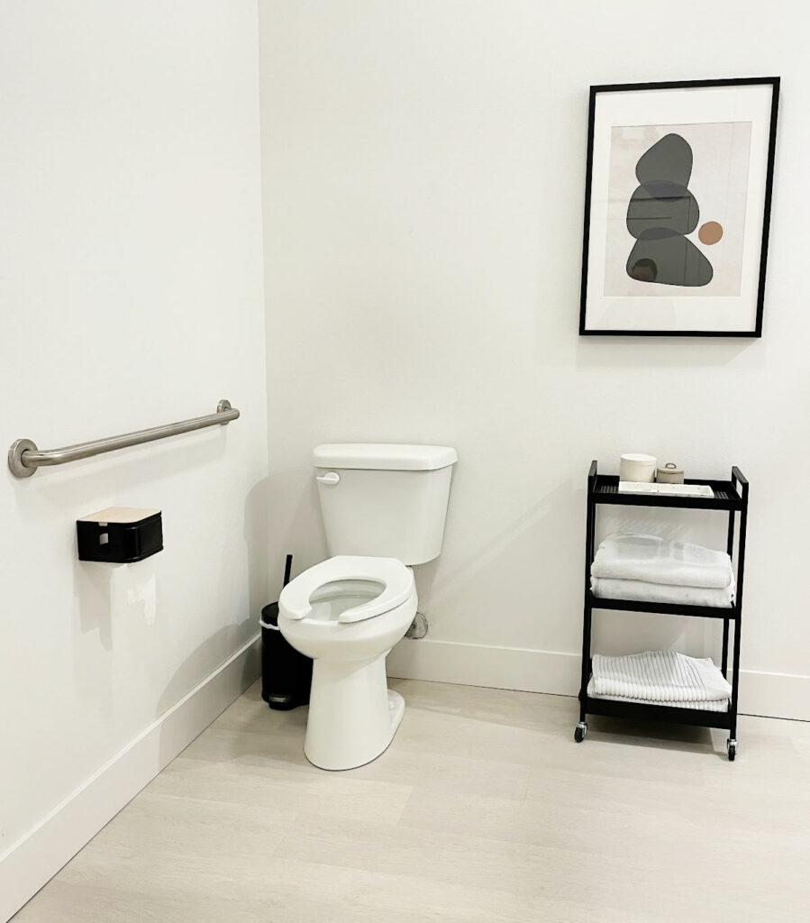 White bathroom with black accessories.