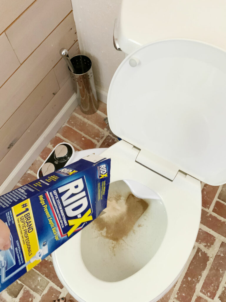 Pouring Rid-X into a toilet